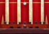 Last-Minute Recusal Jolts Oil Showdown Supreme court courtroom with red curtains and empty judges' bench
