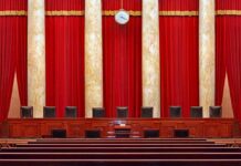 Last-Minute Recusal Jolts Oil Showdown Supreme court courtroom with red curtains and empty judges' bench