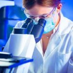Archaea-Bacteria Link Stuns Evolution Debate Scientist using a microscope in a lab