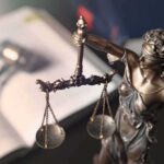 Lady Justice statue holding balanced scales