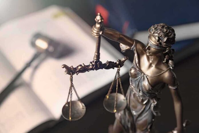 shutterstock_1260591706 Lady Justice statue holding balanced scales