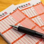 Powerball lottery play slips with a black pen