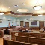 Bank Deception? Racketeering Plot Alleged At Huawei Empty courtroom with wooden benches and judge's bench