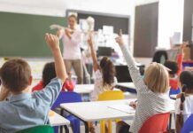 Blue Governors Cornered – Unions Try To Kill ‘Free Money’ Elementary students raise hands in a classroom