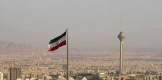 Iranian flag over Tehran skyline with Milad Tower