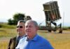 Hezbollah Provokes – Israel Hits Back Hard Ehud Barak and another man outdoors near a missile defense battery