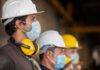 Made-In-America: Largest U.S. Steel Plant Looms Construction workers wearing hard hats and face masks