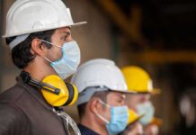 Made-In-America: Largest U.S. Steel Plant Looms Construction workers wearing hard hats and face masks