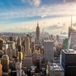 Aerial view of New York City skyline featuring the Empire State Building at sunset