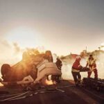 Tour From Hell: Driver Detained After Horror Emergency responders at overturned car crash scene