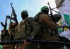 Hamas Engineers Hunted – Bystanders Bleed armed masked men in military gear holding rifles