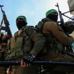 Hamas Engineers Hunted – Bystanders Bleed armed masked men in military gear holding rifles