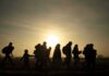 Muslim Entries PLUMMET – Refugees Stop Cold silhouettes of people walking at sunset