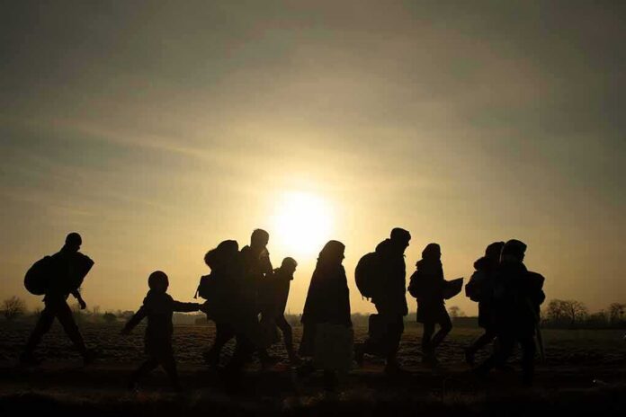 shutterstock_1830065513 silhouettes of people walking at sunset