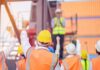 construction workers raising fists during a safety briefing