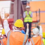 Hiring Crackdown: Vance Puts Citizens First construction workers raising fists during a safety briefing