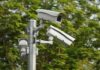 Trump Endorses Flock – Privacy War Erupts surveillance cameras mounted on a metal pole