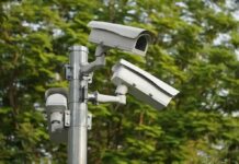Trump Endorses Flock – Privacy War Erupts surveillance cameras mounted on a metal pole