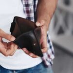 person holding an open empty wallet