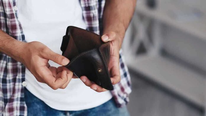 shutterstock_2270762223 person holding an open empty wallet