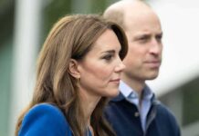 Prince William, Duke of Cambridge, standing slightly behind a woman in profile outdoors