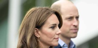Prince William, Duke of Cambridge, standing slightly behind a woman in profile outdoors