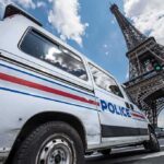 Eiffel Tower Uproar: Women Ordered Invisible? Police van near the Eiffel Tower