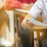 Student Revolt Shakes Modi’s Grip student filling out exam sheet at a desk
