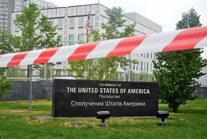 U.S. embassy sign behind red and white barrier tape