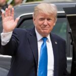 Trump’s High-Stakes Iraq Move Sparks Fury Donald Trump waves while standing beside a black vehicle