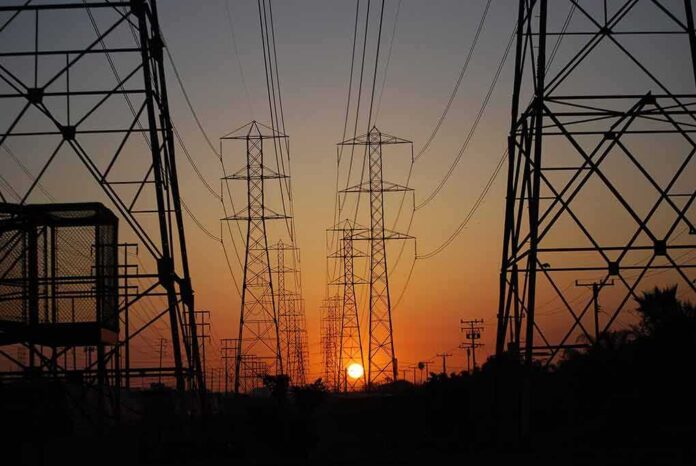 shutterstock_709070596 Power transmission towers at sunset