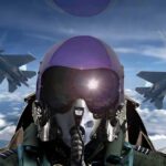 fighter pilot in cockpit with two jets flying in formation