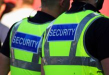Strike Chaos Threatens Google, Amazon Hubs – Guards Walk Out Two security personnel wearing high visibility vests with SECURITY printed on the back