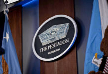 Historic Globe DROPPED – Pentagon Scramble The Pentagon emblem between two flags.