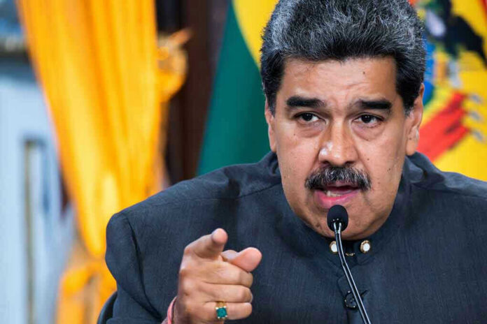 2292443147 Nicolás Maduro speaking at a podium, pointing forward