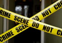 NYCHA Horror: Pregnant Mom Set Ablaze Yellow crime scene tape crossing a doorway
