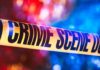 Nine Bodies Found After Erie Rampage – Children Among The Fallen Crime scene tape with blurred emergency lights in background