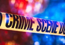 Nine Bodies Found After Erie Rampage – Children Among The Fallen Crime scene tape with blurred emergency lights in background