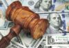 Backdoor Energy Tax? Justices Weigh In Wooden judge's gavel on scattered US dollar bills