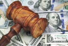 Backdoor Energy Tax? Justices Weigh In Wooden judge's gavel on scattered US dollar bills