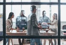 Team meeting in a modern office behind glass windows