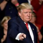 Donald Trump points toward the audience at an event