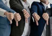 Ban Pardons? Constitutional Crisis Looms Businesspeople giving thumbs down in a row