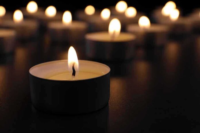 Tealight candle burning with soft glow