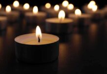 Mass-Casualty – Charred Buses, Dozens Down Tealight candle burning with soft glow
