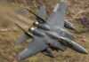 Pentagon’s Payload Monster Crashes the Party Fighter jet banking low over rugged terrain