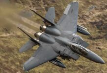 Pentagon’s Payload Monster Crashes the Party Fighter jet banking low over rugged terrain