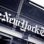 The New York Times sign on a glass building facade