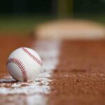Baseball on foul line of infield