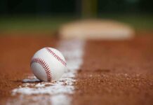 Baseball on foul line of infield